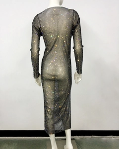 Detail of black fishnet dress with sparkling iridescent rhinestones on a long sleeve model