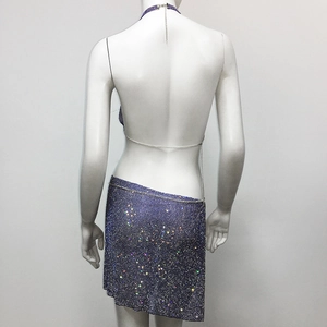 Detail of purple rhinestone halter top and asymmetric skirt set on white mannequin