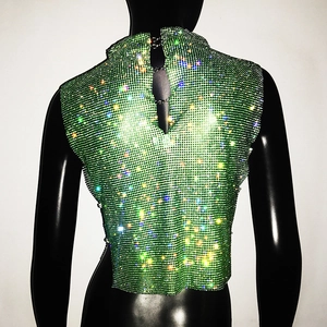 Detail of green rhinestone mesh halter top with metal chain links and open back design