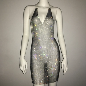 Macro detail of silver rhinestone mesh fabric and deep V neckline on a party dress