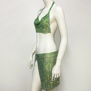 Detail of green rhinestone mesh crop top and high slit skirt set on a display mannequin
