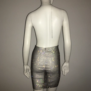 Detail of silver mesh dress with sparkling rhinestones and delicate metal back chain