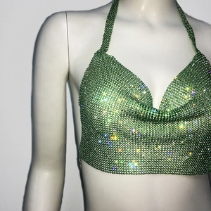 Close-up of sparkling green rhinestone halter crop top with shimmering crystal texture
