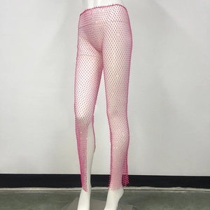 Detail of hot pink rhinestone fishnet pants with elastic mesh and split leg opening
