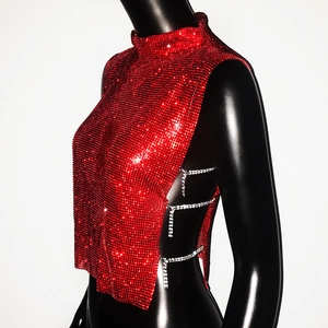Detail of red rhinestone mesh top with side silver chains on a black mannequin