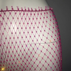Detail of hot pink rhinestone mesh skirt with sparkling crystals and fringe tassel waist