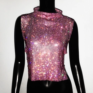 Detail of magenta rhinestone mesh cropped top featuring high neck and sparkling crystals