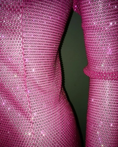 Close-up of rose pink mesh dress featuring shimmering silver rhinestones detail