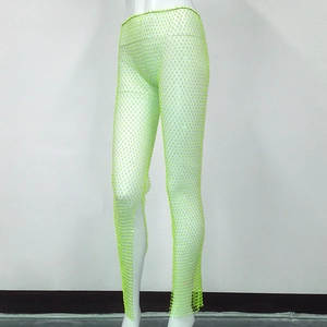 Close-up of neon green mesh fishnet pants with sparkling rhinestone details and elastic band