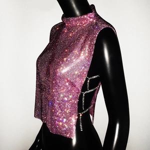 Detail of pink rhinestone mesh cropped top with side metal chains on a black mannequin