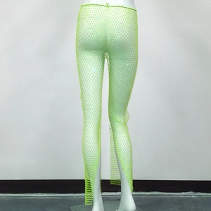 Macro detail of high-stretch neon green fishnet trousers with shimmering rhinestones