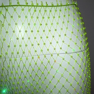 Detailed macro view of fluorescent green mesh fabric with luxury sparkling rhinestones