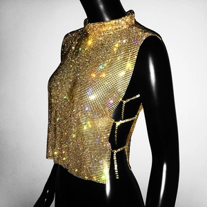 Detail of gold rhinestone mesh top featuring a high neck and lace-up side design