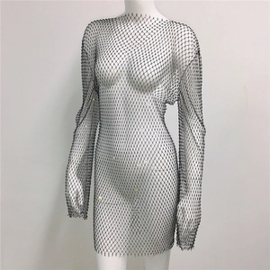 Close-up of black mesh fishnet dress with sparkling silver rhinestones and long sleeves