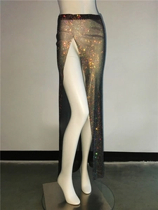 Close-up of sparkling colorful rhinestones on a black mesh skirt with a high side slit