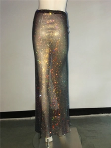 Detail of sheer black mesh maxi skirt featuring sparkling rainbow rhinestones and side slit