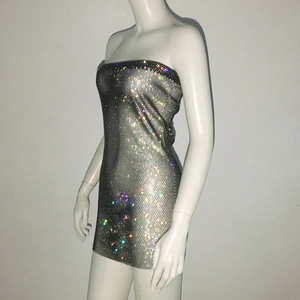 Detail of rhinestone mini dress featuring shimmering crystals on metallic fishnet mesh fabric