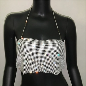 Macro detail of silver rhinestone mesh halter top with metallic chain strap for parties