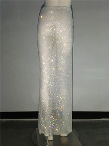 Macro detail of high-density silver rhinestones on a sparkling luxury maxi skirt
