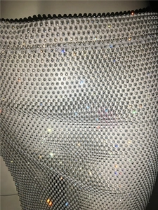 Macro view of silver rhinestone mesh fabric with sparkling crystals and fine woven details