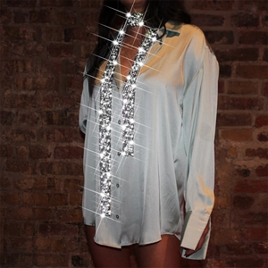 Detailed view of shimmering rhinestone tie paired with silky satin shirt for party wear