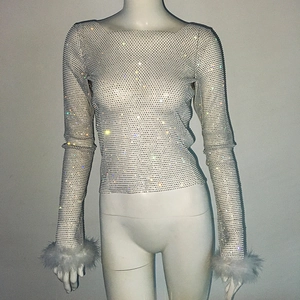 Close-up of rhinestone mesh top featuring faux fur cuffs and shimmering crystal details