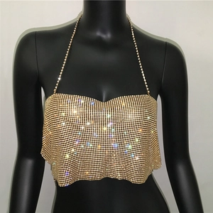 Detail of gold metal mesh sequins on halter top showing shimmering rhinestone texture