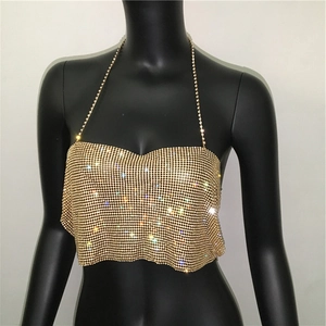 Detailed close-up of shiny gold sequin halter top with sparkling rhinestone shoulder straps