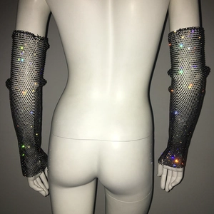 Detail of long black mesh arm sleeves embellished with sparkling colorful rhinestones