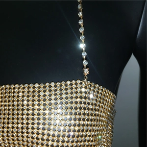 Close-up of golden mesh tank top with sparkling rhinestones and delicate thin straps