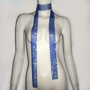 Detail of dark blue rhinestone mesh scarf showing shimmering crystals on metal grid