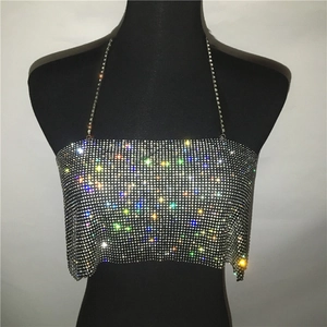 Close-up of sparkling silver rhinestone halter top with delicate metal chains for parties