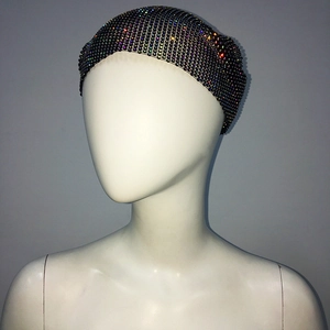 Detailed close-up of a black mesh headpiece with vibrant colorful rhinestones for parties