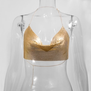Detailed view of shimmering gold sequin halter top with metallic chainmail texture
