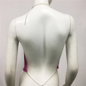 Macro detail of hot pink metal sequin halter top with backless chain design