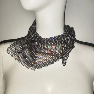 Détail d'un bandeau en maille noire avec des strass multicolores étincelants et travaillés