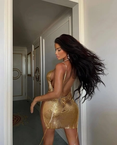 Detailed backless design of golden metallic sequin halter dress with chain mail texture