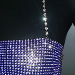 Macro detail of royal blue mesh top with sparkling rhinestones and chain straps