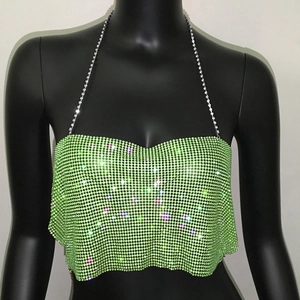 Macro detail of high-density green rhinestones on party camisole with silver chain straps