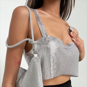 Detail of shimmering silver metal sequin mesh crop top with matching chain handbag