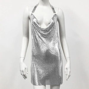 Detail of silver metal sequin chainmail dress showing glossy mesh and halter neckline