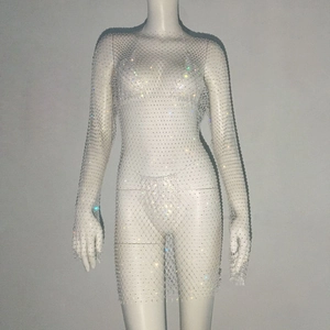 Detailed view of white mesh dress with long sleeves and shimmering rhinestone embellishments