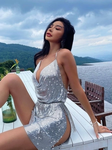 Elegant silver sequin backless halter dress with high slit and chain fringe for parties