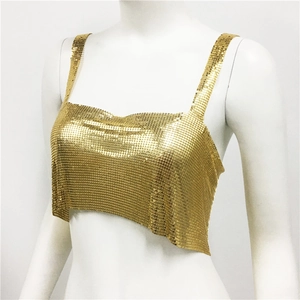 Detailed macro view of the golden metal mesh sequins on a party crop top camisole