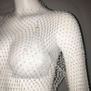 Detailed view of white mesh rhinestone cover-up with shimmering crystal embellishments