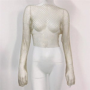 Detailed macro view of the mesh texture and sparkling rhinestone inlay on a crop top