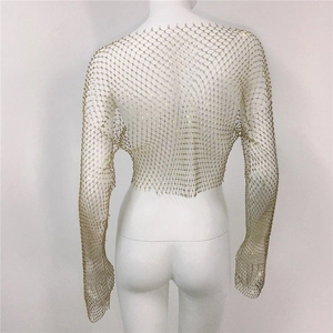 Detail of gold fishnet top with shimmering rhinestones and long sleeves on a mannequin