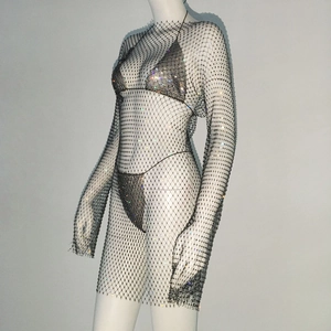 Detailed close-up of sparkling colorful rhinestones on a metallic mesh fishtail dress