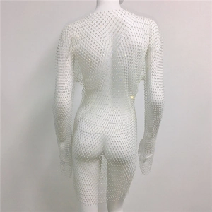 Close-up of white mesh dress with sparkling rhinestones and delicate hexagonal pattern