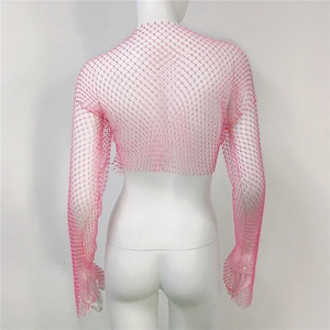 Close-up of pink long sleeve mesh shrug with sparkling rhinestones on mesh fabric